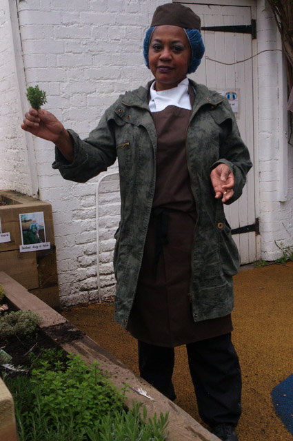 Chefs picks herbs from school plot 